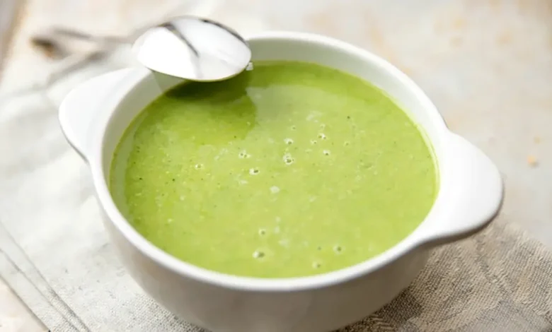 Bol de soupe de cresson garnie de crème fraîche et de croûtons.